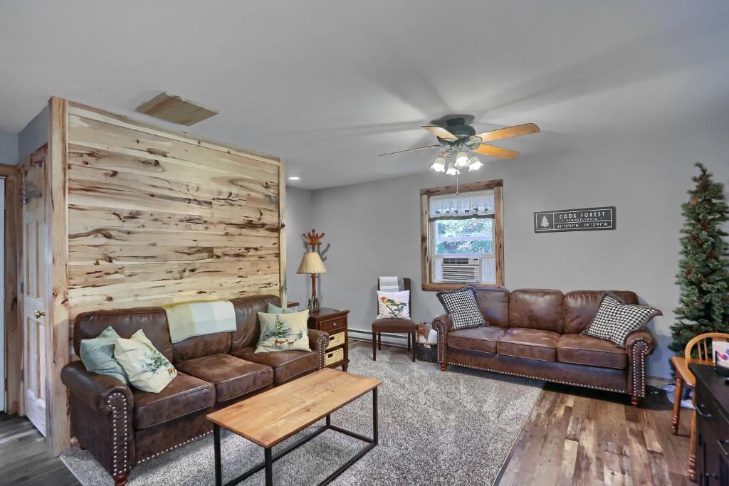a living room with two couches and a ceiling fan at 15 off Summer Special Pet Friendly WiFi in Marienville