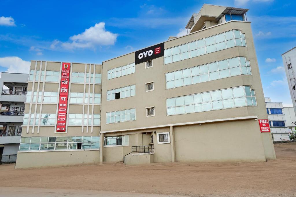 an office building with anovo sign on it at Hotel O Pearl Inn Executive in Chakan