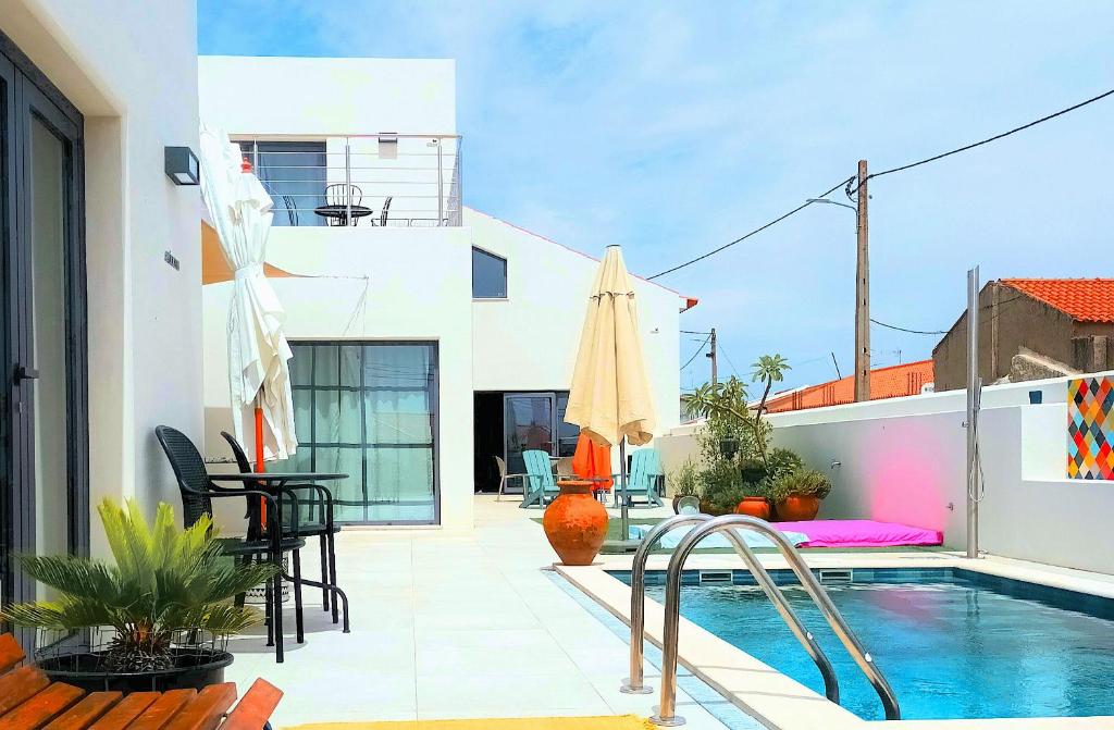 a patio with a pool and a table and chairs at Casa do Campinho B&B boutique country house in Reguengos de Monsaraz