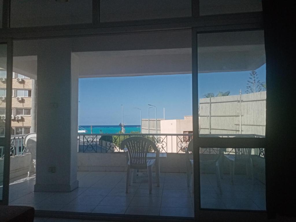 a balcony with a chair and a view of the ocean at Buer Youth Hostel in Marsa Matruh
