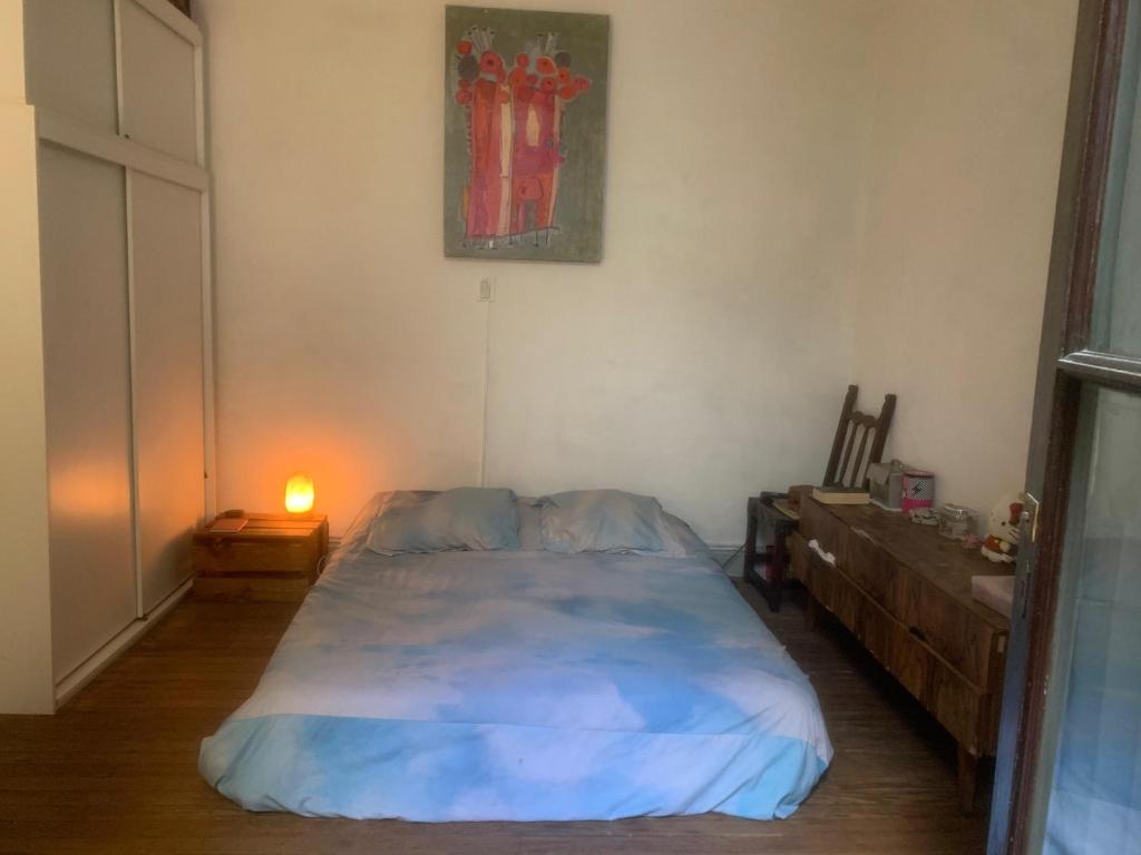 a bedroom with a large bed and a dresser at Amplia y bonita habitacion en ph compartido en Recoleta in Buenos Aires