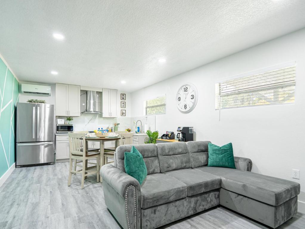 a living room with a couch and a kitchen at Dora's Haven Getaway-Cozy 1Bedroom with Boat or Camper Parking- Free in Mount Dora