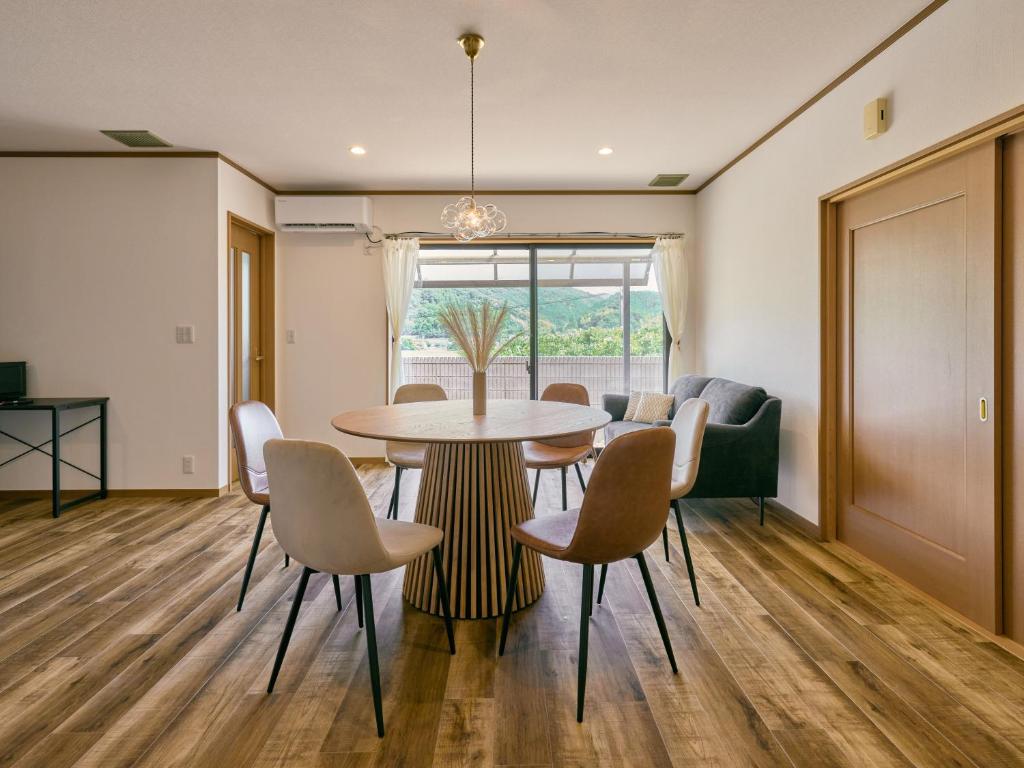 a dining room with a table and chairs at 美祢Terrace in Mine