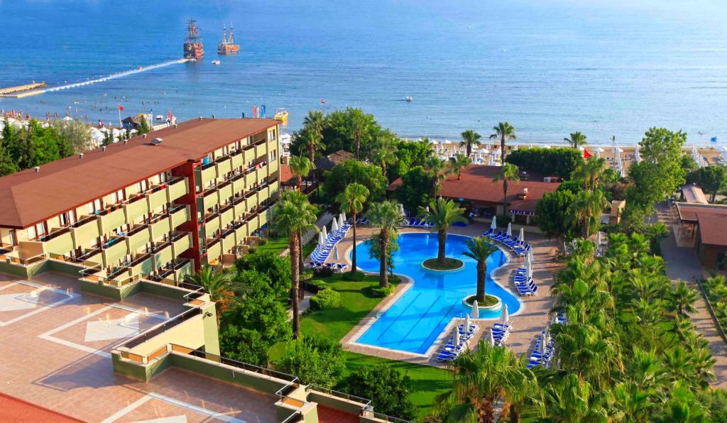 an aerial view of a hotel with a swimming pool and the ocean at Hotel Grand Side in Side