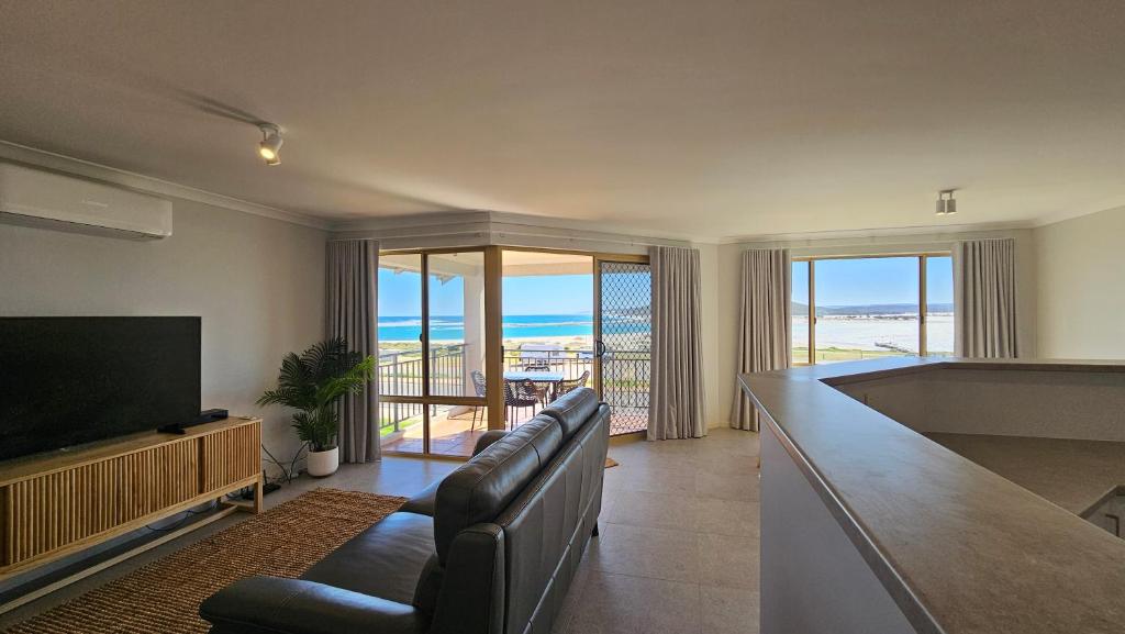 ein Wohnzimmer mit Couch und Flachbildfernseher in der Unterkunft Pelican Shore Villa 3A- Kalbarri, WA in Kalbarri
