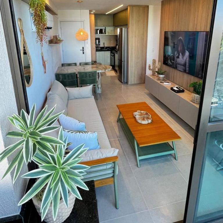 a living room with a couch and a table at Capri Residence Luxo 02 quartos by Premium Reservas in Porto De Galinhas