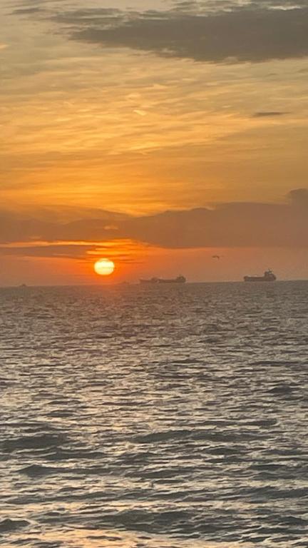 a sunset over the ocean with ships in the distance at Olon de Haciendas Olonche in Olón