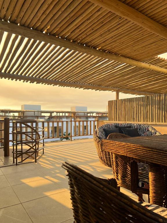 a patio with a bench on a roof at SW Rustica Apartamentos in Canoa Quebrada