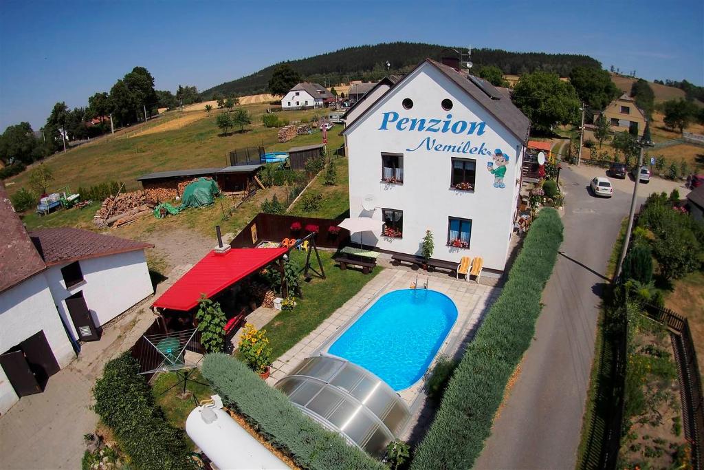 an aerial view of a building with a swimming pool at Penzion Nemílek in Kolinec