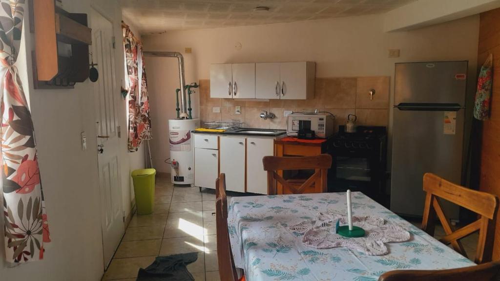 a kitchen with a table and a kitchen with a table and chairs at Departamento turístico SMA in San Martín de los Andes