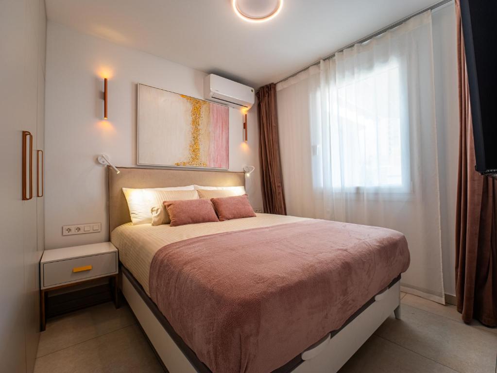 a bedroom with a large bed with a window at Deluxe Atico Puerto de la Cruz in Puerto de la Cruz
