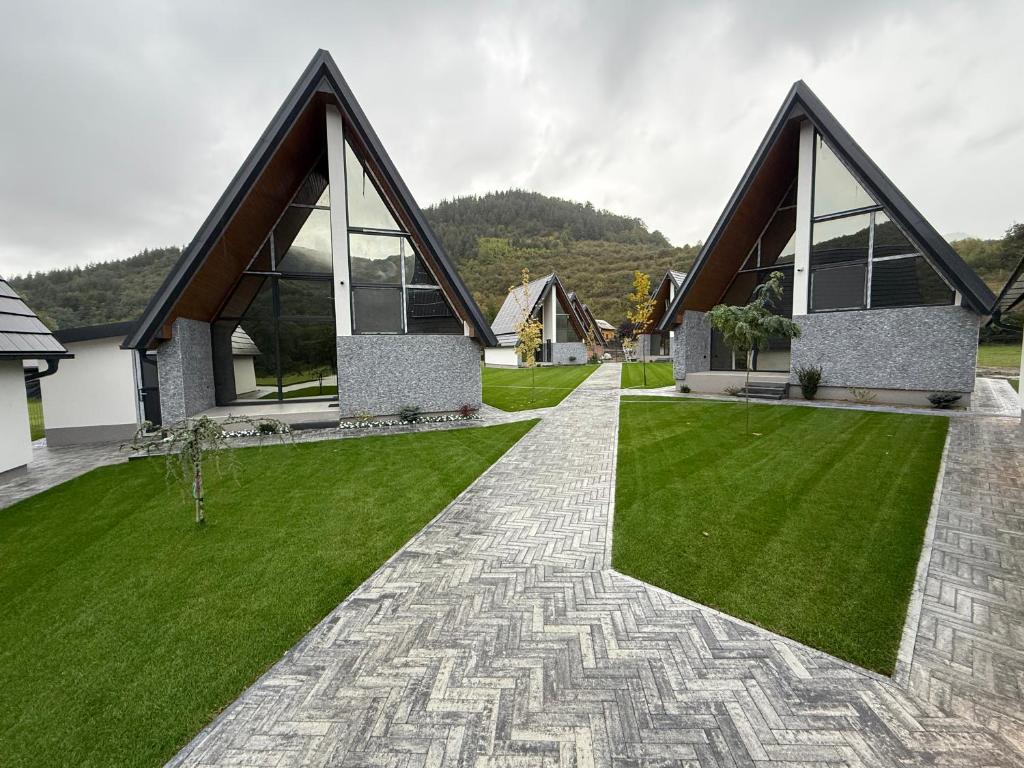 a house with a green lawn in front of it at Lex Houses in Praid