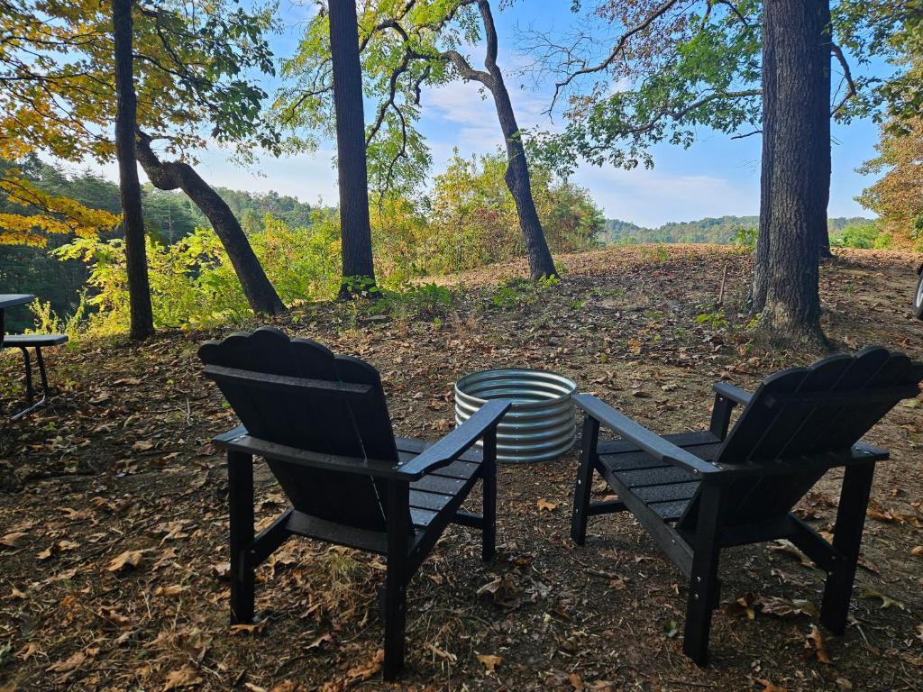 two chairs and a table in the woods at The Hocking Hills Store Campsite #3 in Logan