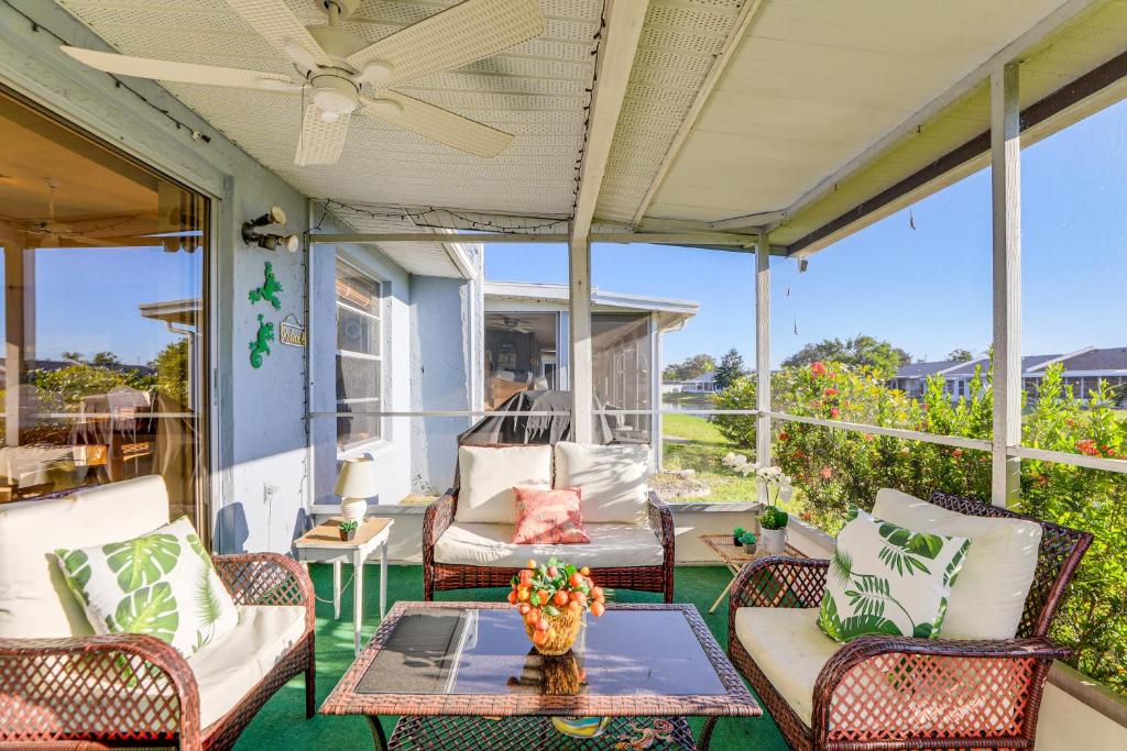 a porch with chairs and a table and a fan at Pool Access Condo 4 Mi to Bradenton Riverwalk! in Cedar Hammock