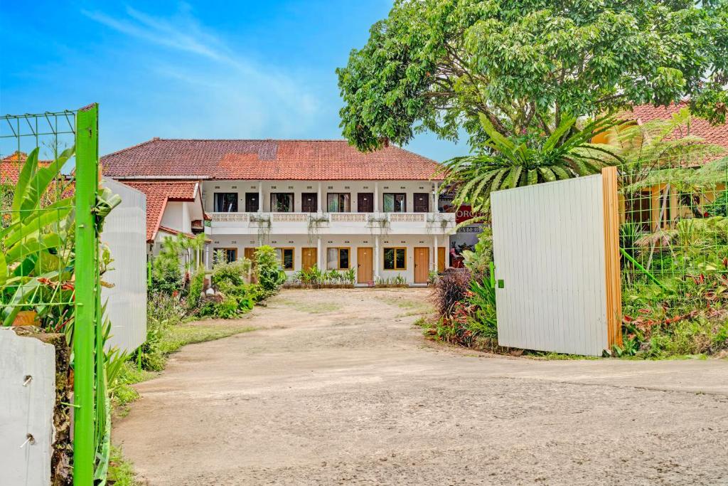 an old house with a gate in front of it at Collection O Subang near Ciater Subang formerly Orchid Villa Ciater in Ciater