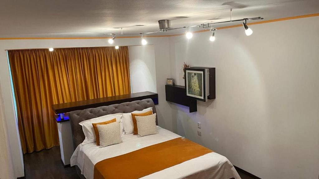 a bedroom with a bed with white sheets and pillows at Apartament Horatio in Galaţi