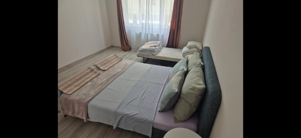 a bedroom with a large bed and a chair at Apartament Casa Dia Sibiu in Sibiu