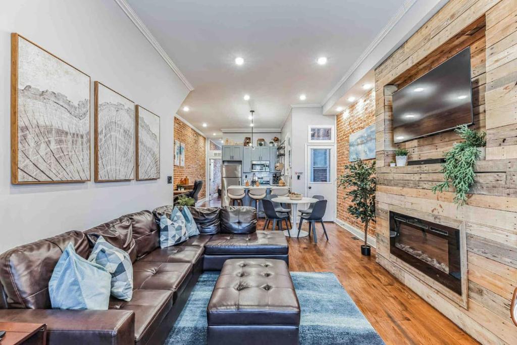 a living room with a couch and a fireplace at Large Bi-Level 3BR w Patio - 10 min to DT in Philadelphia