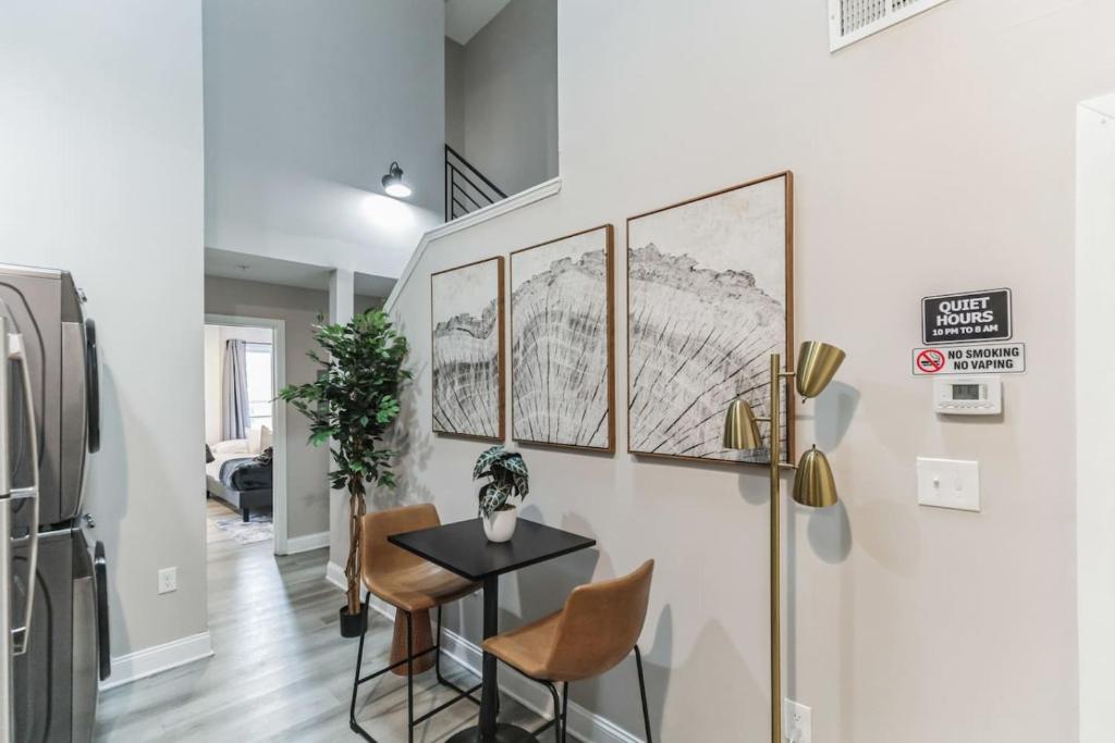 a dining room with a table and a refrigerator at Bi-Level 2BR Loft in Old City in Philadelphia