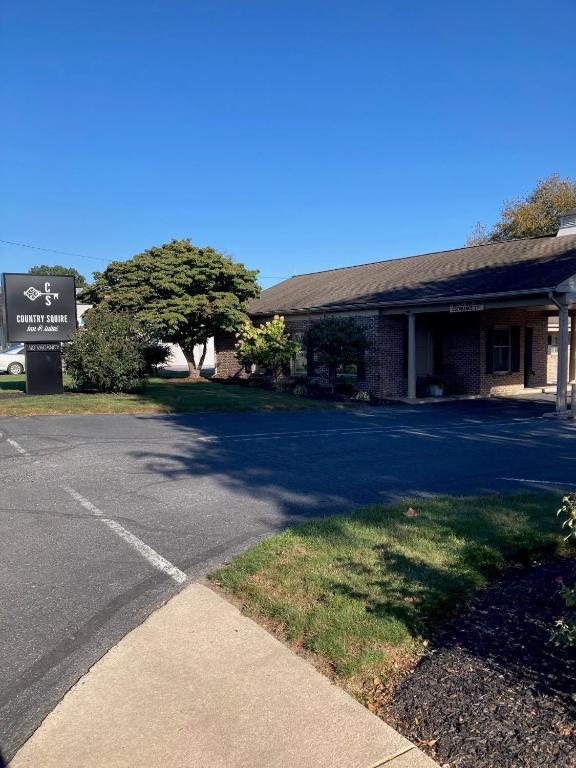 a parking lot in front of a building at Country Squire Inn and Suites in New Holland