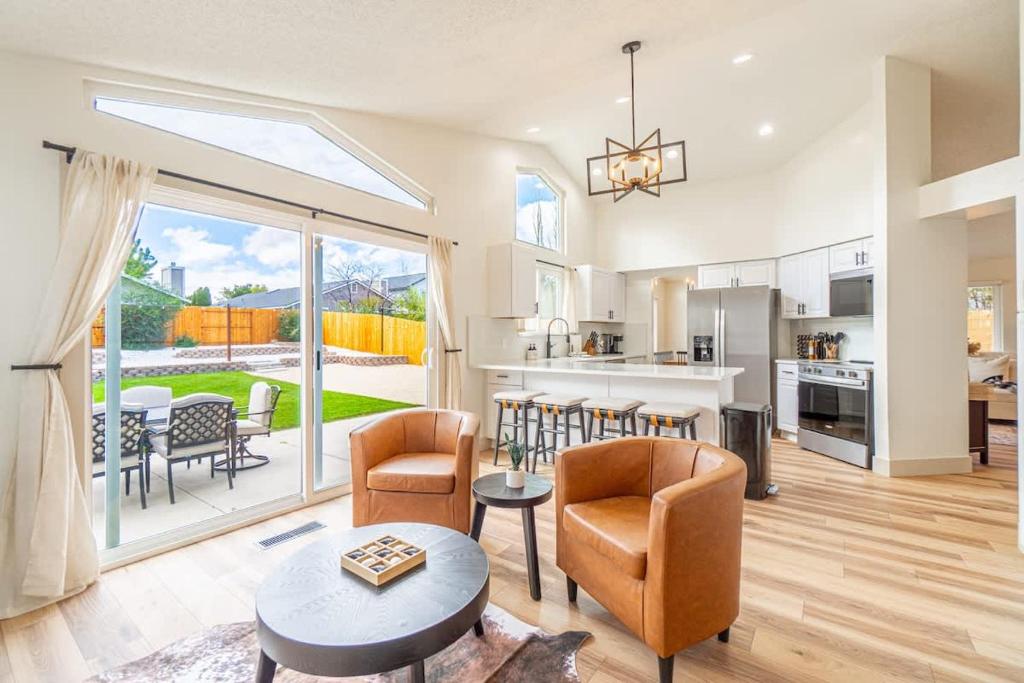 a kitchen and living room with a table and chairs at Modern Western Retreat Pet Friendly 4 Bed 2 Bath in Reno