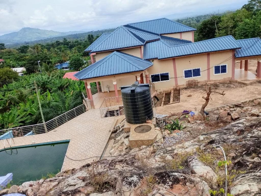 a house with a water tank in front of it at Sako's Home 