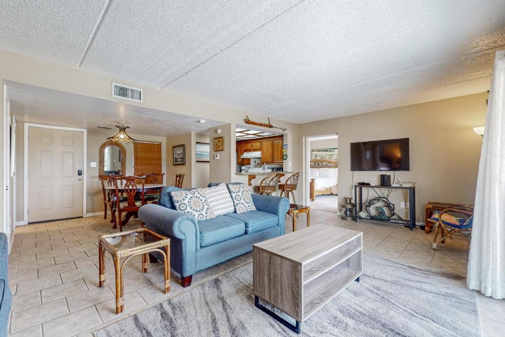 een woonkamer met een blauwe bank en een tafel bij Marlin Arms Condominiums #9 in South Padre Island
