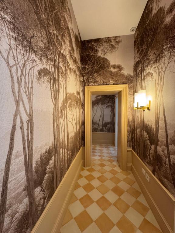 a hallway with a wall mural of trees at Gradini dell arte in Naples