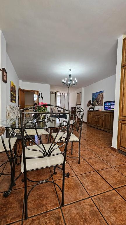 a dining room with chairs and a table in a room at La Casita Nueva in El Socorro