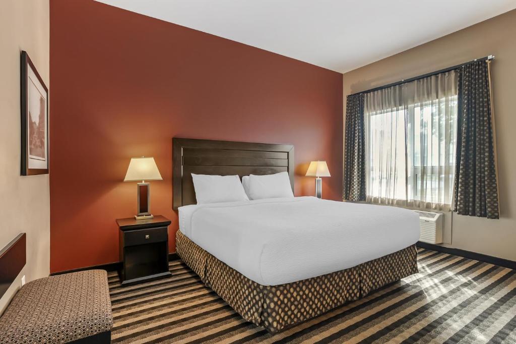 a bedroom with a large bed and a window at Best Western Blairmore in Saskatoon