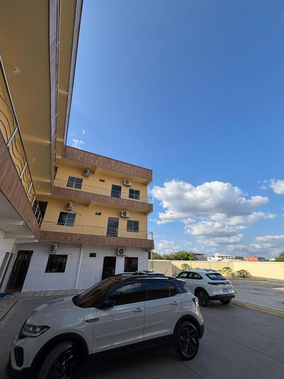 a white car parked in front of a building at Pousada Amorim in Frecheirinha