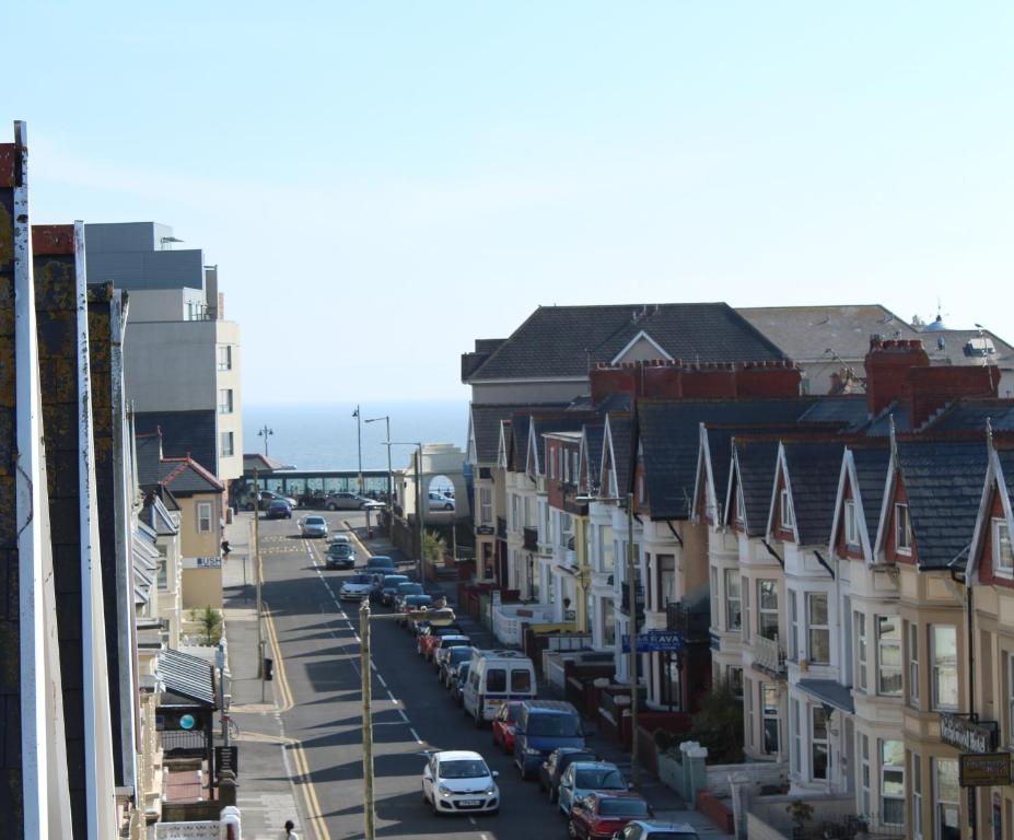 a city street with cars parked on the street at Apartment Mary street in Porthcawl