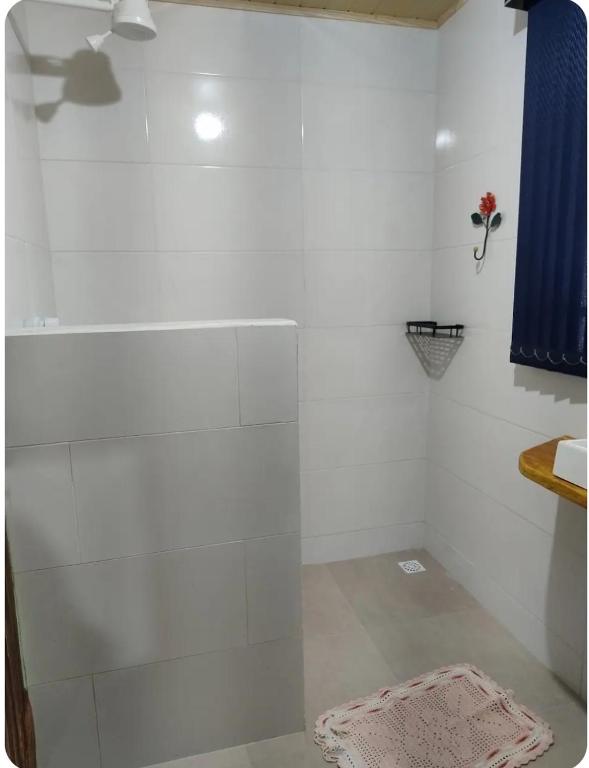 a bathroom with a shower with a glass door at Recanto da paz in Monte Verde