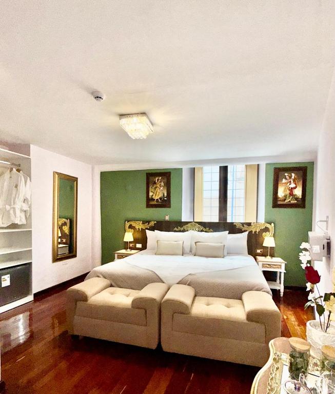 a bedroom with a large bed and a couch at Ayni Boutique Hotel in Cusco