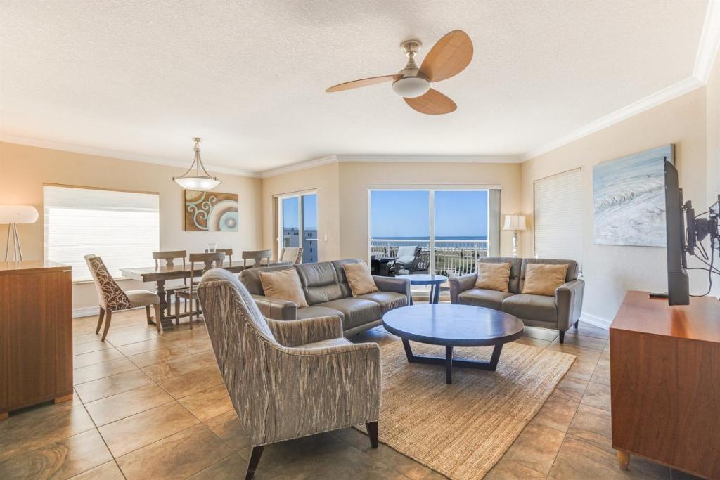 a living room with a couch and a table at 3BR Luxury Penthouse Panoramic Views in St Pete Beach