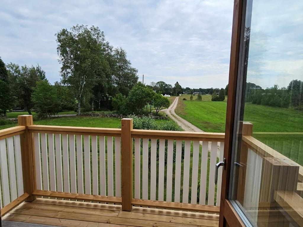 a porch with a view of a field and a road at 8 person holiday home in Ryssby in Ryssby