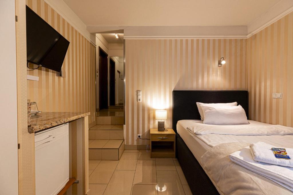 Ένα ή περισσότερα κρεβάτια σε δωμάτιο στο Business Pension Gasper