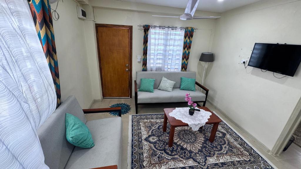 a living room with a couch and a table at Rai-Ki-Wai Accomodation in Suva
