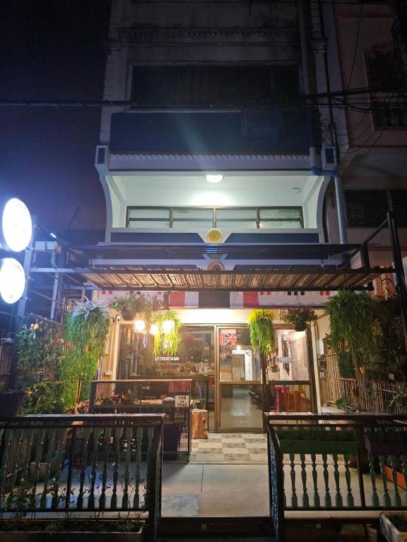 a building at night with benches in front of it at MT friendhome&hostel2 in Phuket