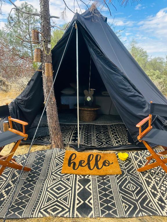 a tent with a sign that says help on the floor at Rocky Ridge Glamping Yosemite in Coarsegold