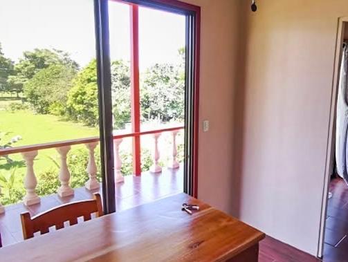 a dining room with a table and a large window at Pavones Seaside View in Pavones