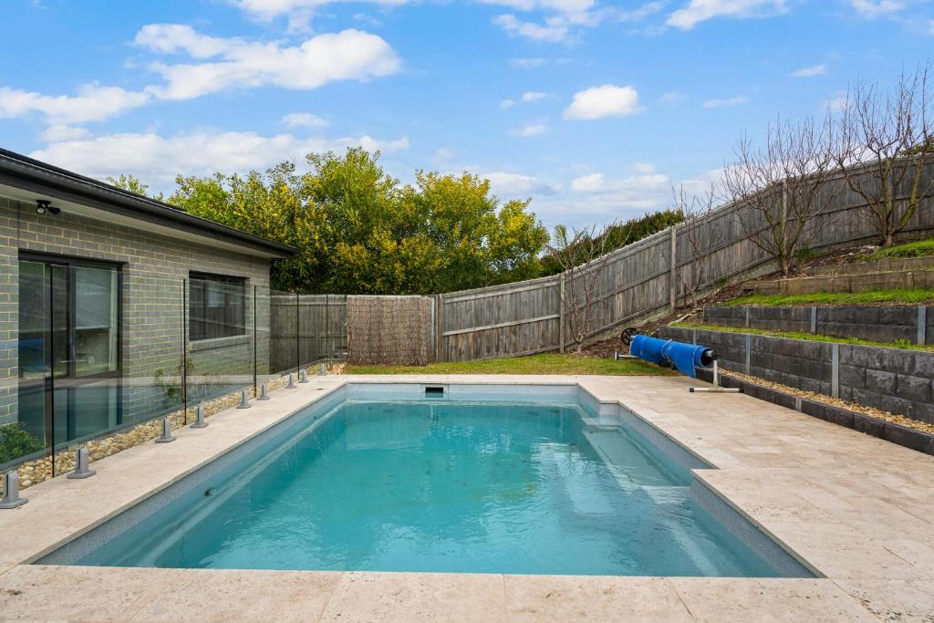 a swimming pool in the backyard of a house at Tea Tree Pool Retreat in Inverloch
