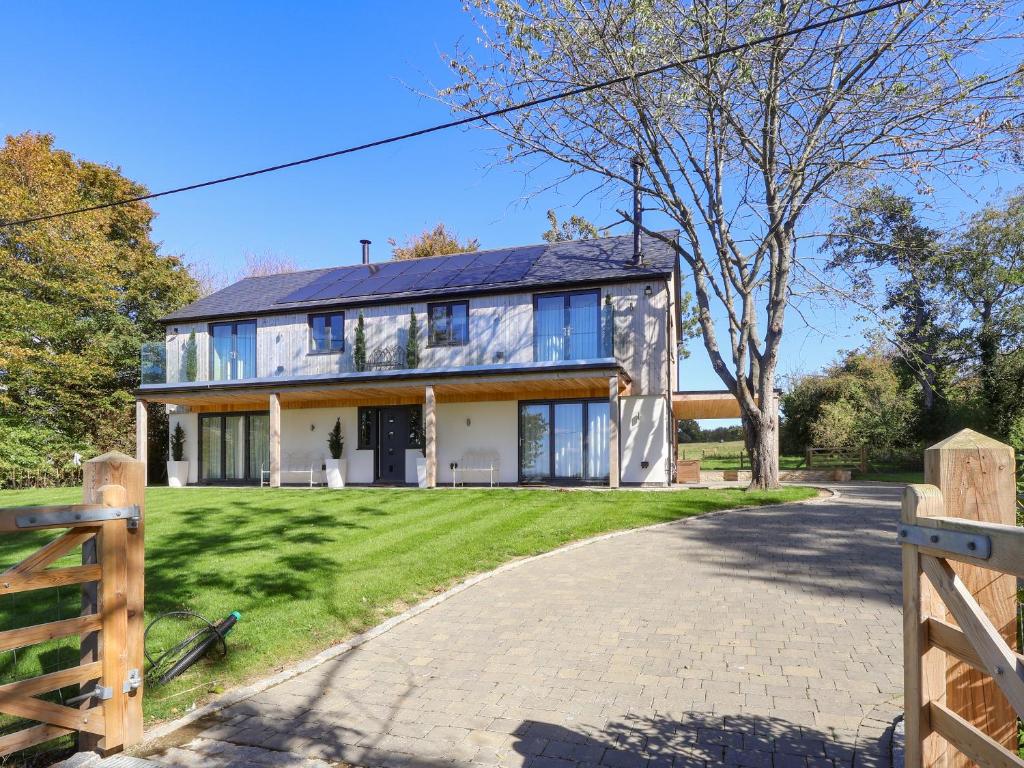 a house with a fence and a driveway at Brookside in Highway