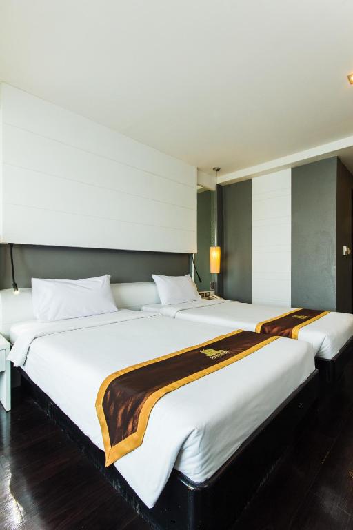 Postel nebo postele na pokoji v ubytování Khon Kaen Hotel