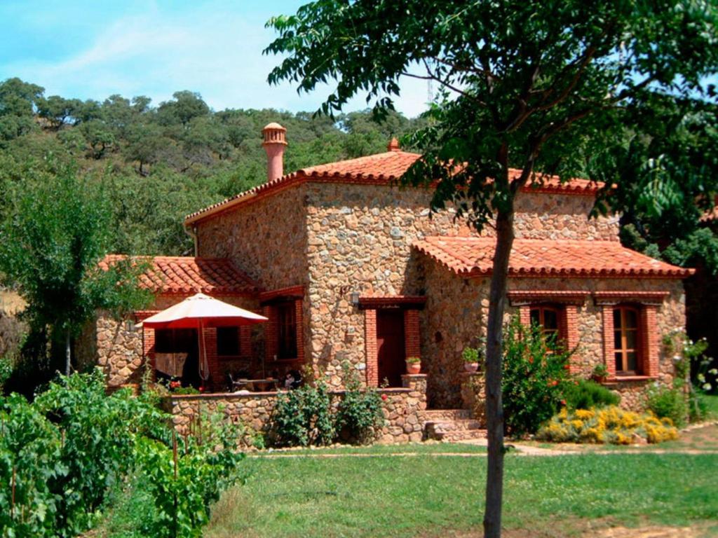 a large stone house with a red roof at Charming Stone Houses at Molino in Alájar