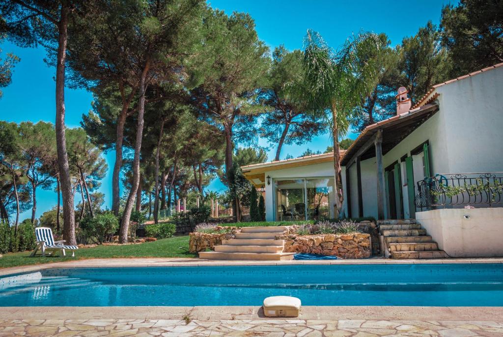 a house with a swimming pool in front of a house at Villa Defendum in Vallauris