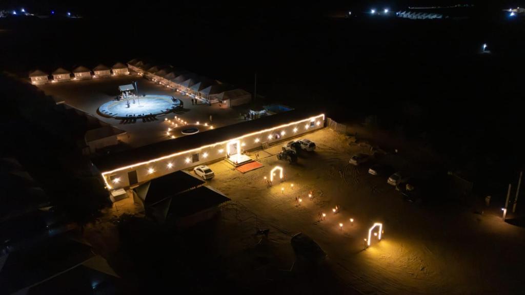 山姆Mumal Desert Camp - Jaisalmer !的享有大楼的顶部景色,晚上有灯