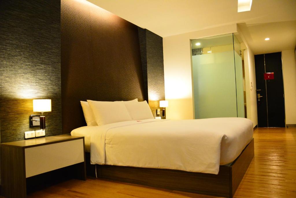 Postel nebo postele na pokoji v ubytování Trinity Silom Hotel