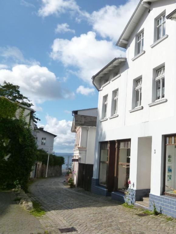 a white building on the side of a street at Homelig Altstadt Ferienwohnungen Sassnitz Fewo 4 in Sassnitz