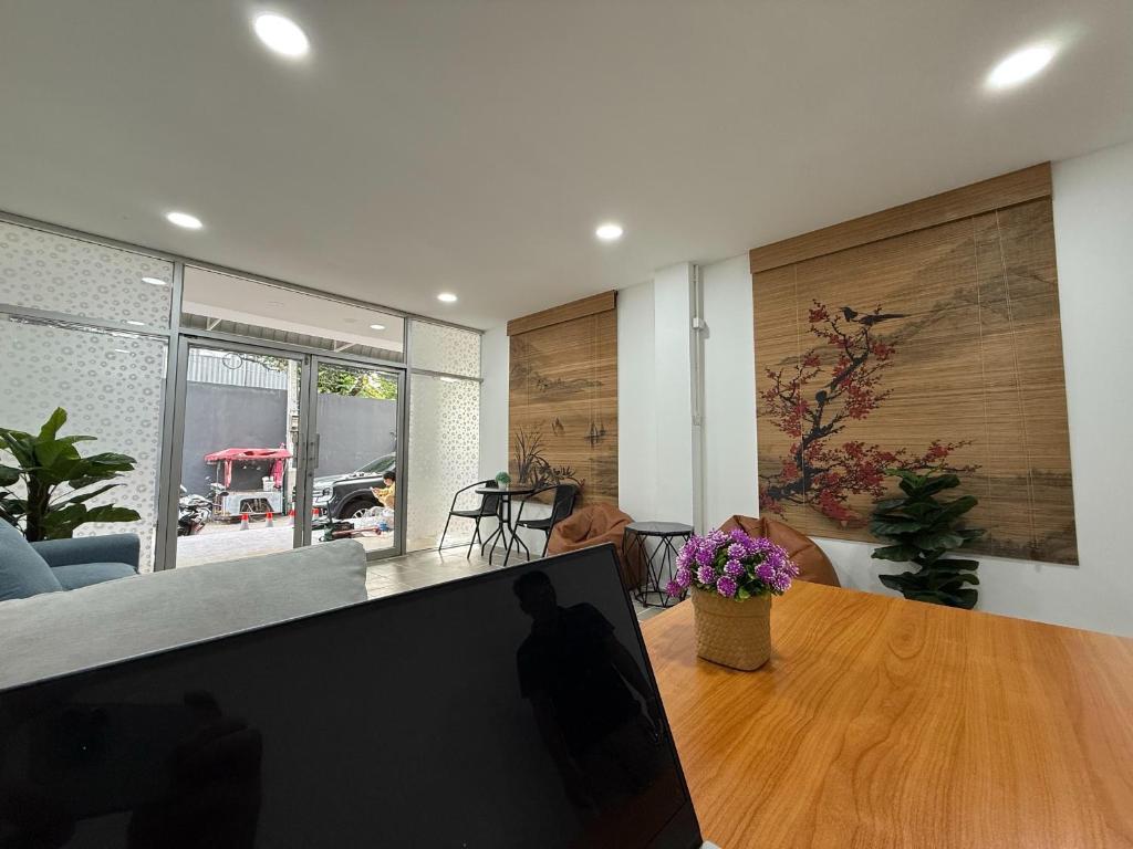 a living room with a table with a laptop on it at Sukhumvit 48 separated room quiet and comfortable with fast internet and smart TV in Bangkok